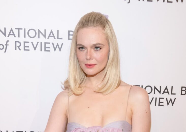 Elle Fanning Pairs a Baby-Doll Dress With Faux Fur and Blinding Rubies